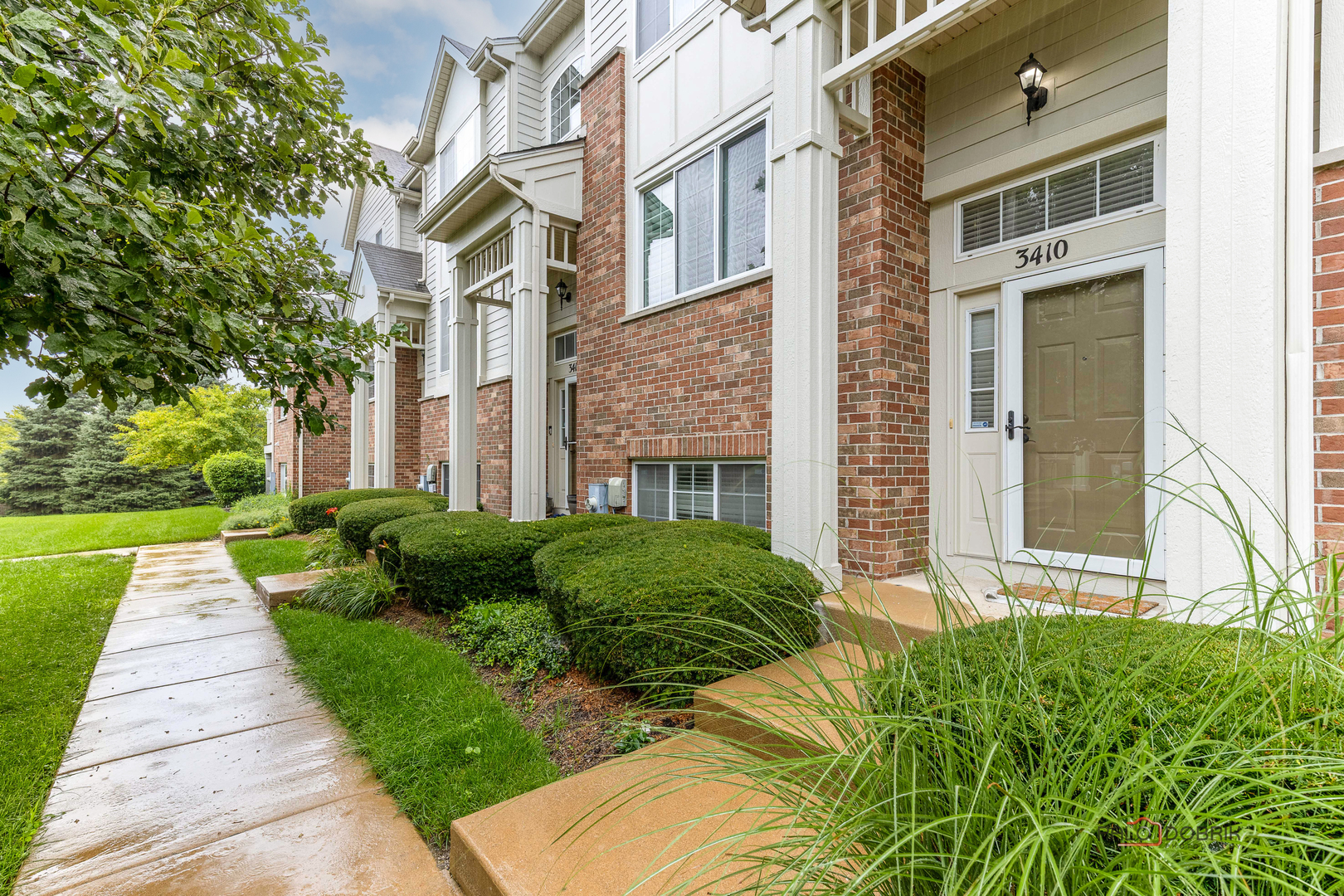 3410 Cameron Drive Elgin, IL 60124 - Photo 4 of 28 a view of a brick house with a yard and plants