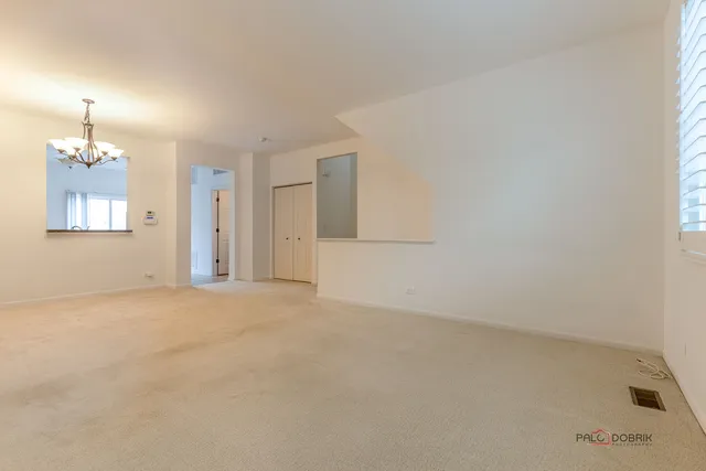 en empty room with windows and fireplace