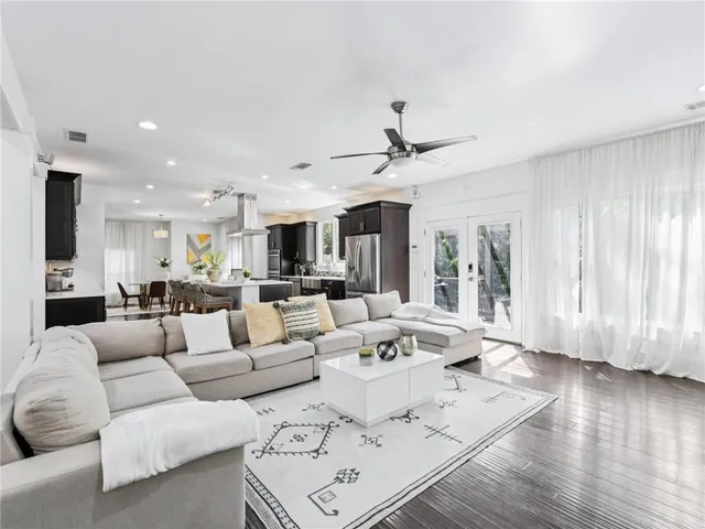 a living room with furniture and wooden floor
