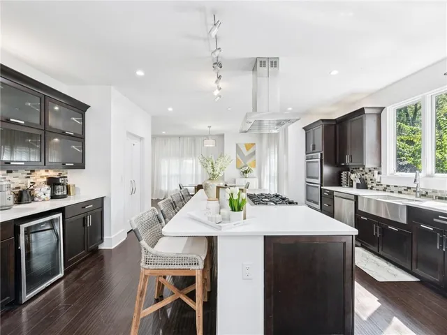 a kitchen with granite countertop a sink stove and cabinets