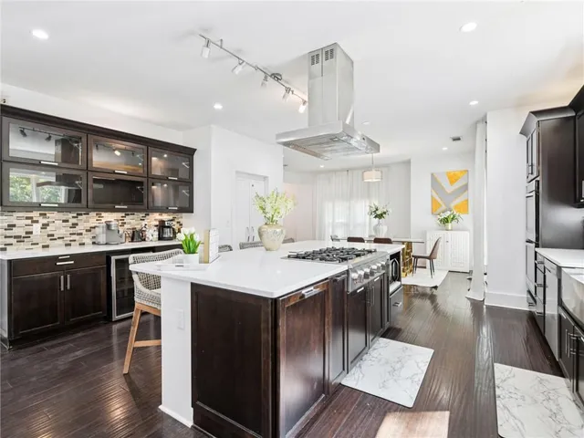 a kitchen with stainless steel appliances granite countertop a stove and a refrigerator