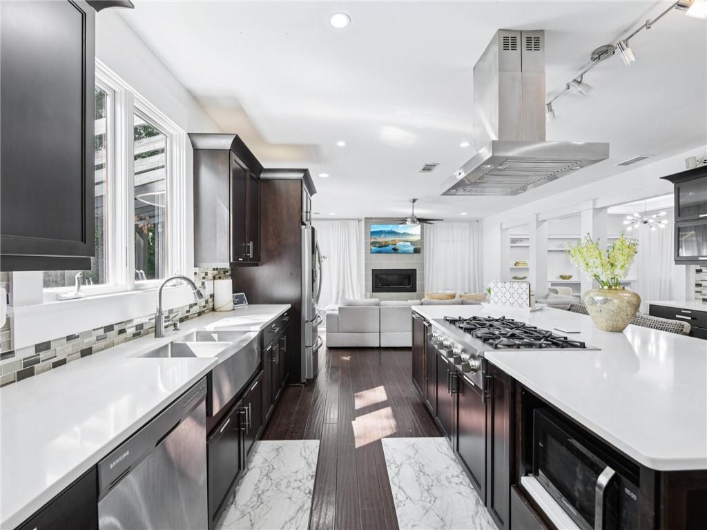 1399 North Druid Hills Road Northeast Atlanta, GA 30319 - Photo 14 of 58 a kitchen with granite countertop a sink stove and cabinets