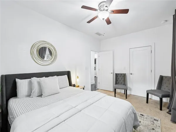 a bedroom with a bed couch and window