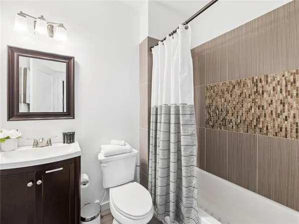 a living room with stainless steel appliances kitchen island granite countertop a sink and a stove