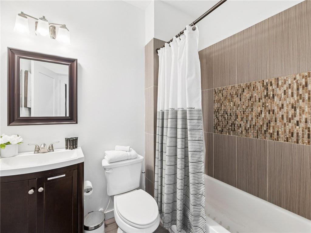 1399 North Druid Hills Road Northeast Atlanta, GA 30319 - Photo 25 of 58 a bathroom with a sink a toilet and shower curtain