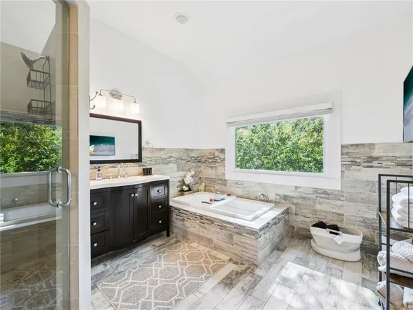 a bedroom with furniture and a large window