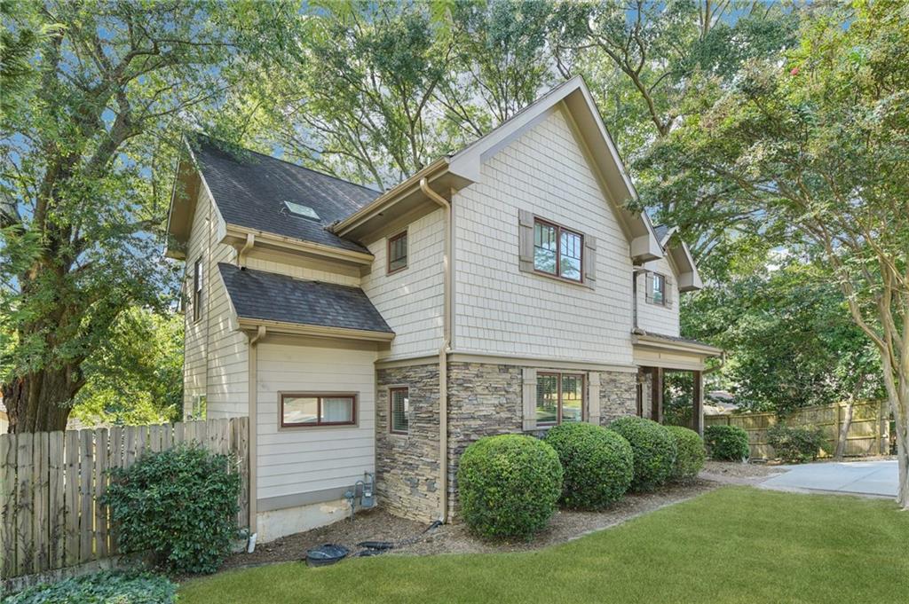 1399 North Druid Hills Road Northeast Atlanta, GA 30319 - Photo 3 of 58 a front view of a house with a yard