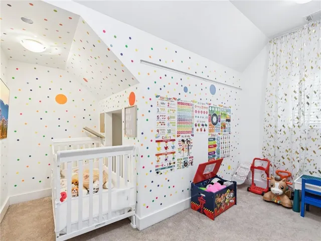 a bathroom with a bathtub shower sink vanity mirror and toilet