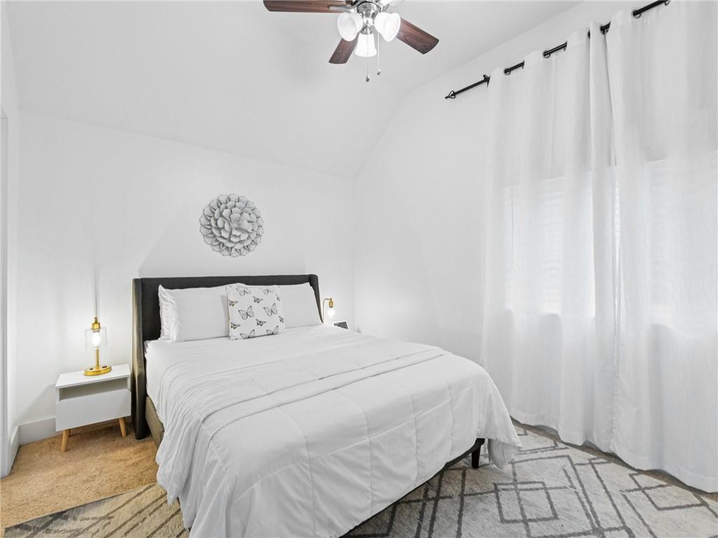 1399 North Druid Hills Road Northeast Atlanta, GA 30319 - Photo 33 of 58 a bedroom with a bed and a chandelier