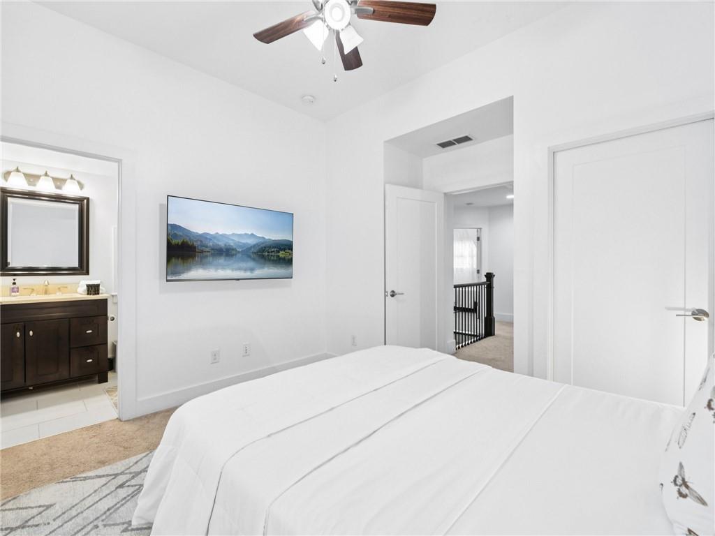 1399 North Druid Hills Road Northeast Atlanta, GA 30319 - Photo 34 of 58 a bedroom with a bed and a flat screen tv