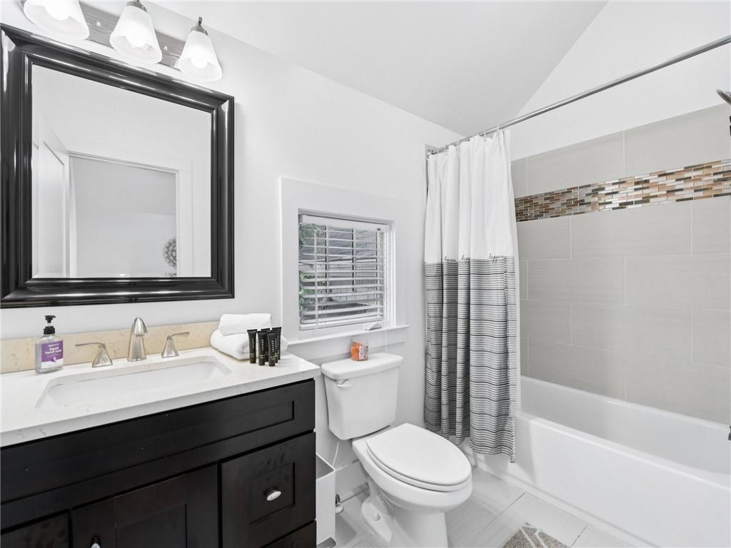 1399 North Druid Hills Road Northeast Atlanta, GA 30319 - Photo 35 of 58 a bathroom with a bathtub shower sink vanity mirror and toilet