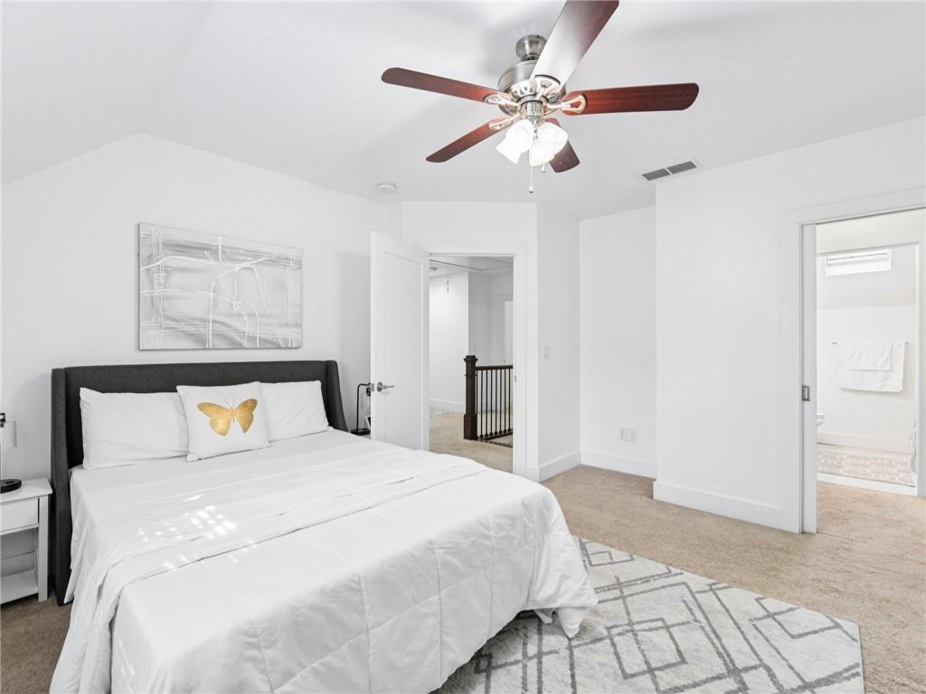 1399 North Druid Hills Road Northeast Atlanta, GA 30319 - Photo 37 of 58 a bedroom with a large bed and a chandelier