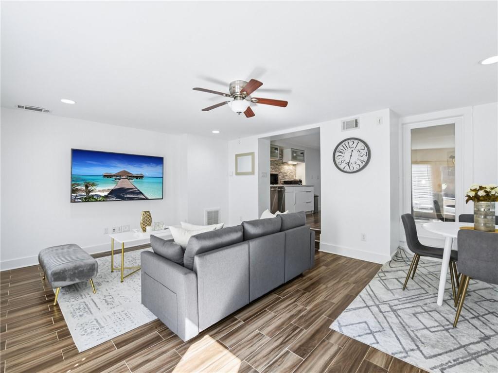 1399 North Druid Hills Road Northeast Atlanta, GA 30319 - Photo 40 of 58 a living room with couches a coffee table and dresser with wooden floor