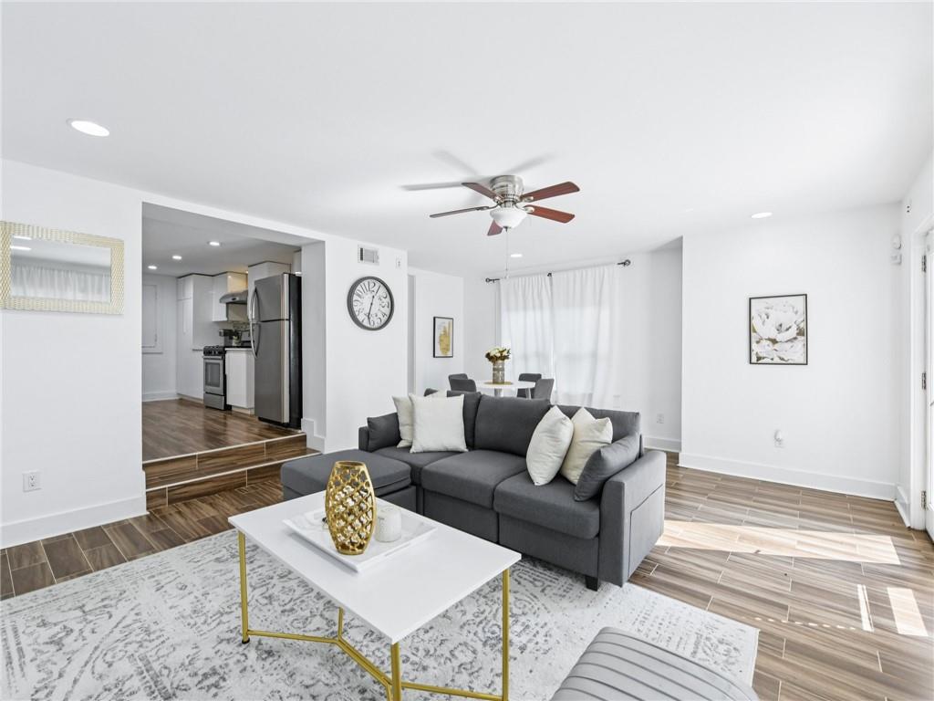 1399 North Druid Hills Road Northeast Atlanta, GA 30319 - Photo 41 of 58 a living room with furniture and a wooden floor