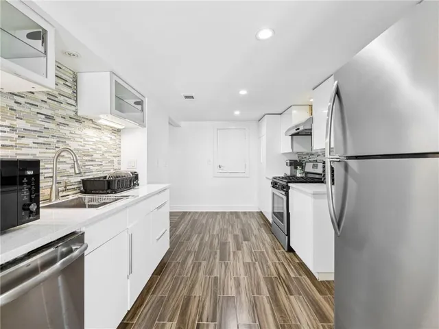 a bathroom with a sink toilet and mirror