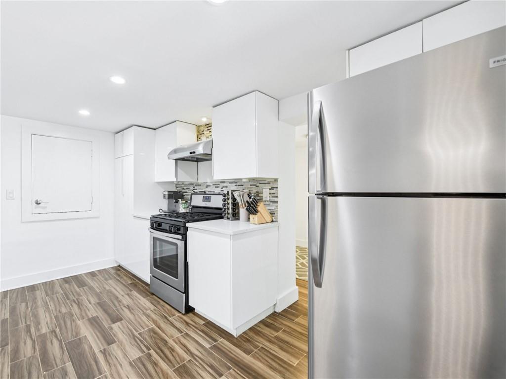 1399 North Druid Hills Road Northeast Atlanta, GA 30319 - Photo 43 of 58 a kitchen with a refrigerator and a stove top oven