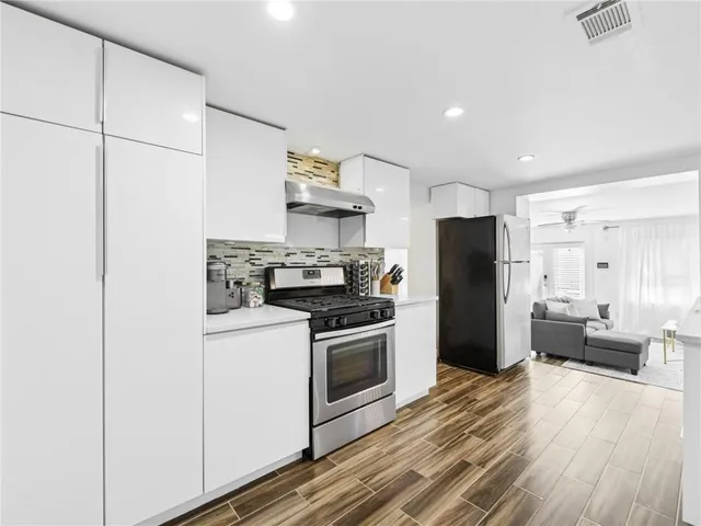 a view of a patio with table and chairs and wooden floor