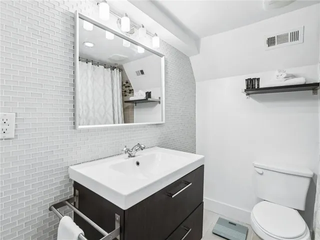 a view of a patio with table and chairs and potted plants
