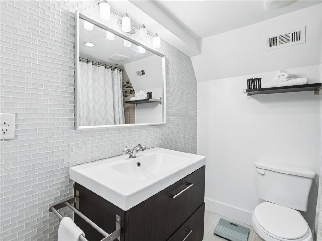 1399 North Druid Hills Road Northeast Atlanta, GA 30319 - Photo 49 of 58 a bathroom with a sink toilet and mirror