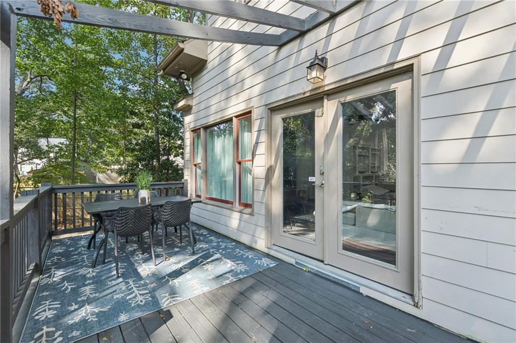 1399 North Druid Hills Road Northeast Atlanta, GA 30319 - Photo 52 of 58 a view of a patio with table and chairs and wooden floor