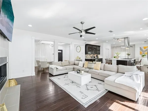 a large kitchen with granite countertop a stove a sink a dining table and chairs