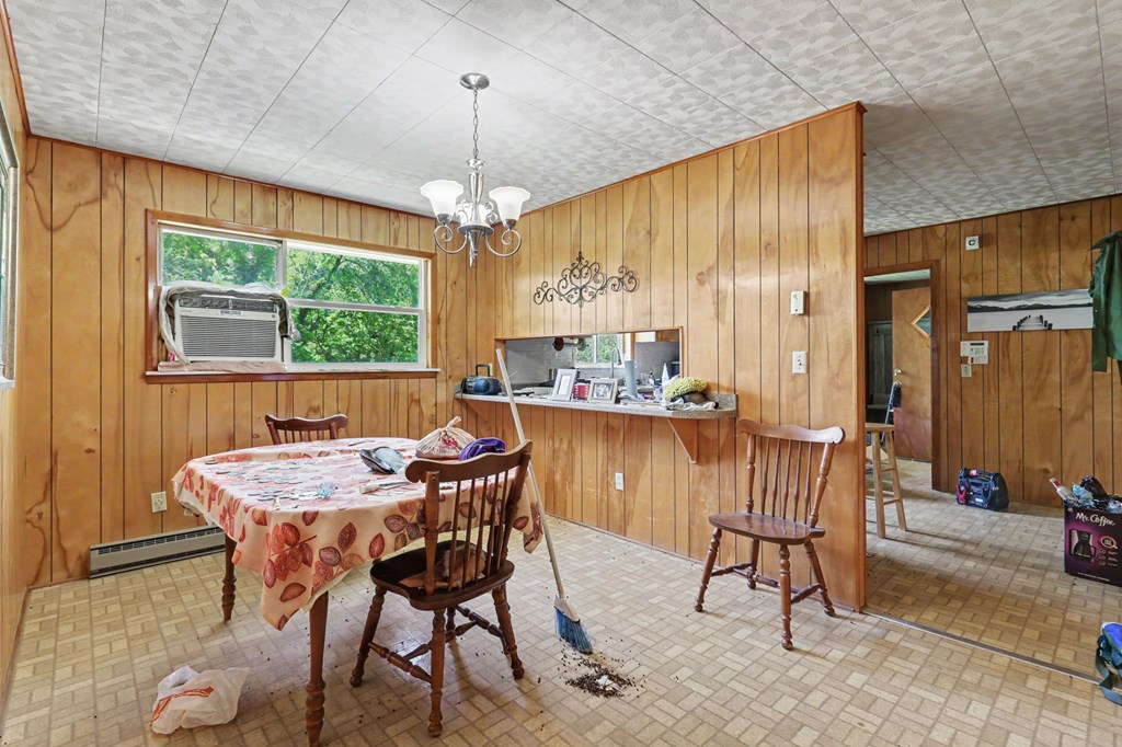 63 Fort Butler Street Murphy, NC 28906 - Photo 12 of 30 a dining room with furniture a chandelier and wooden floor