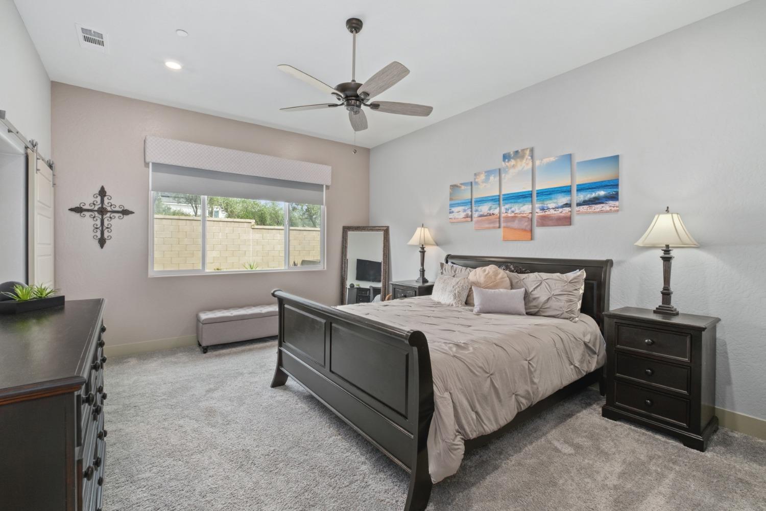 859 Maclure Avenue Madera, CA 93636 - Photo 19 of 53 a bedroom with a bed and a chandelier