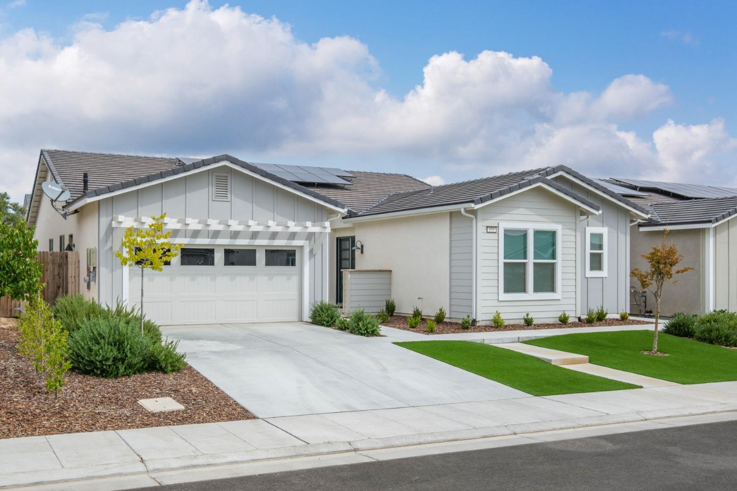 859 Maclure Avenue Madera, CA 93636 - Photo 2 of 53 a front view of a house with a yard and garage