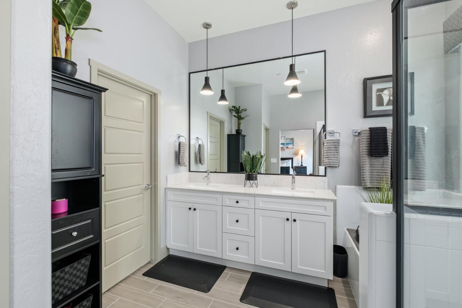 859 Maclure Avenue Madera, CA 93636 - Photo 21 of 53 a spacious bathroom with a shower a sink and a mirror