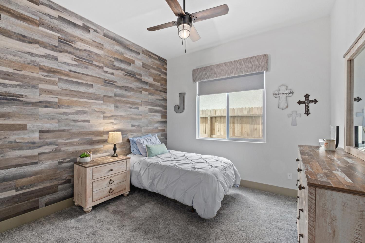 859 Maclure Avenue Madera, CA 93636 - Photo 25 of 53 a bedroom with a bed dresser and a window