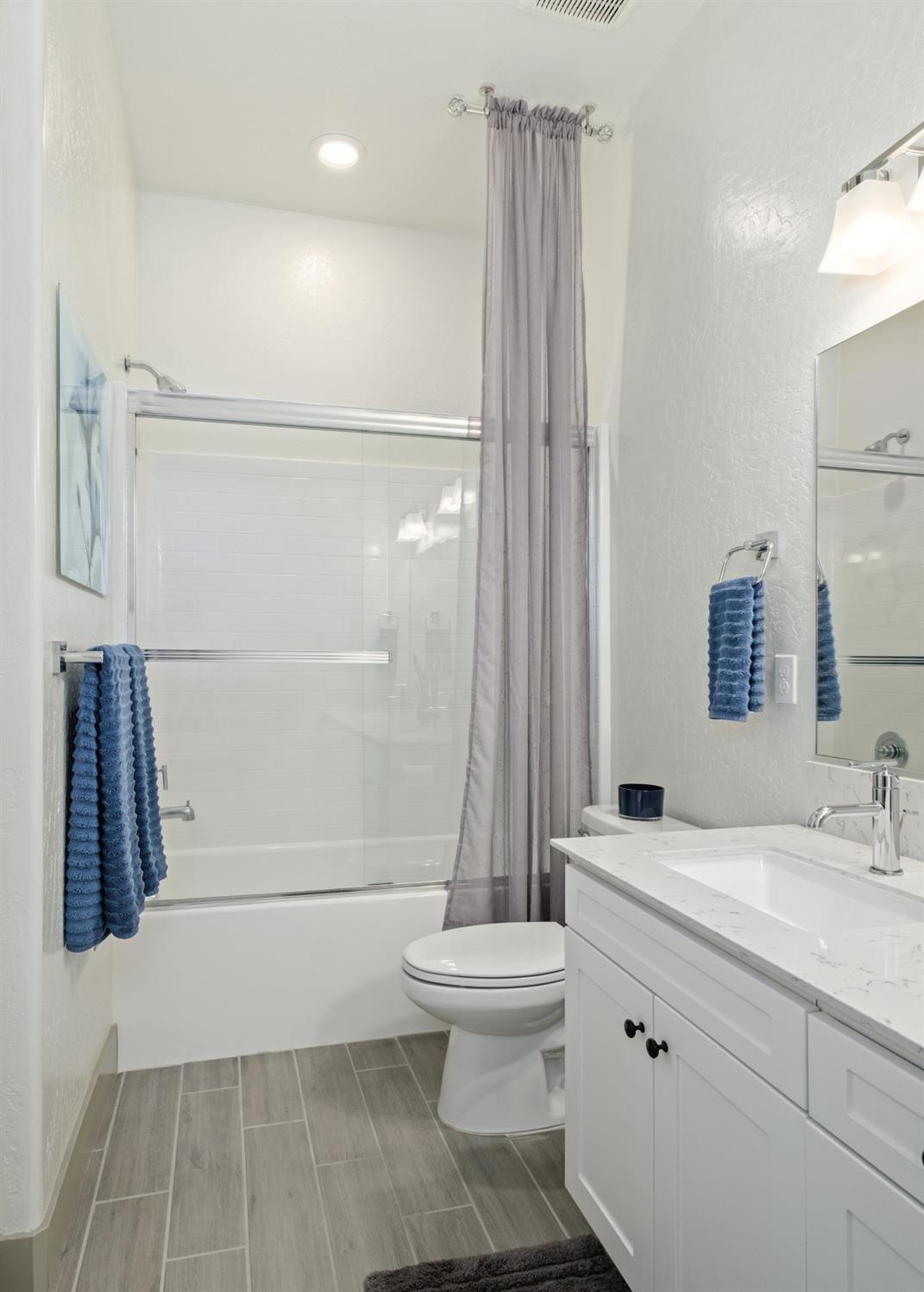 859 Maclure Avenue Madera, CA 93636 - Photo 27 of 53 a bathroom with a sink a toilet and shower