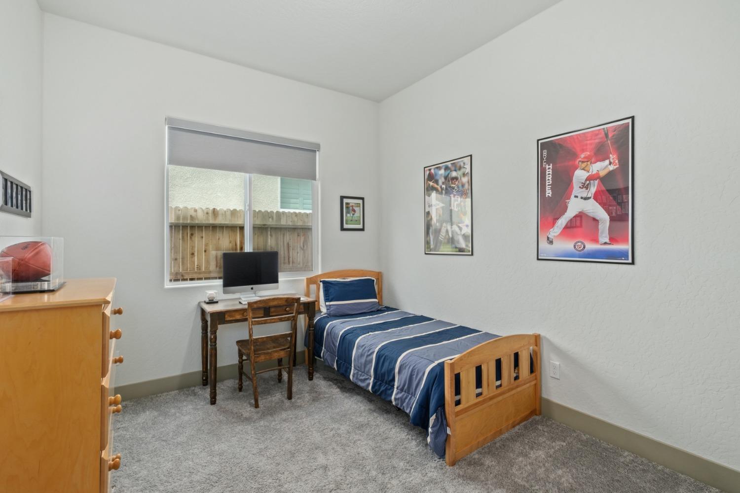 859 Maclure Avenue Madera, CA 93636 - Photo 28 of 53 a bedroom with a bed and a desk