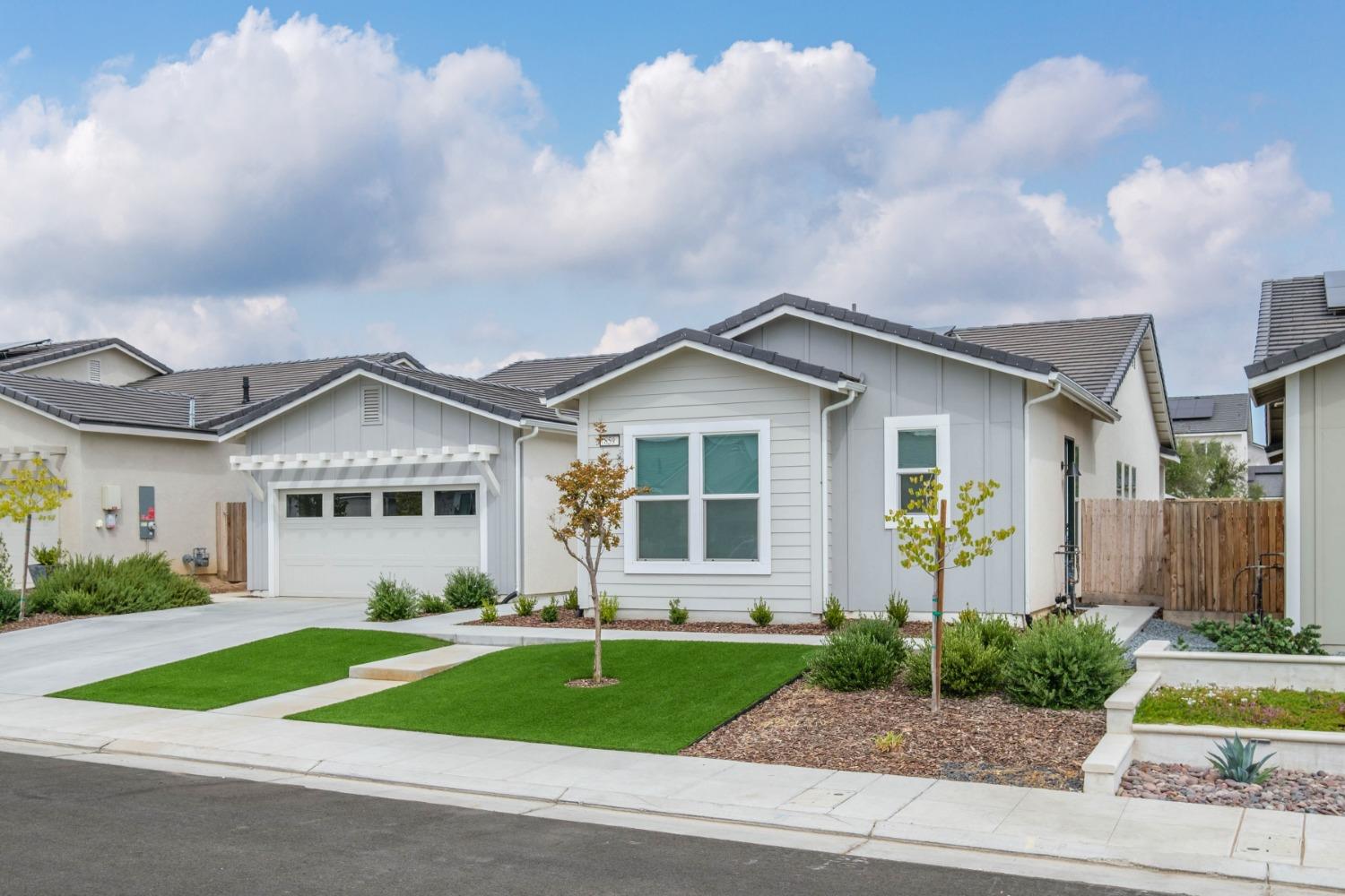 859 Maclure Avenue Madera, CA 93636 - Photo 3 of 53 a front view of a house with a yard and garage