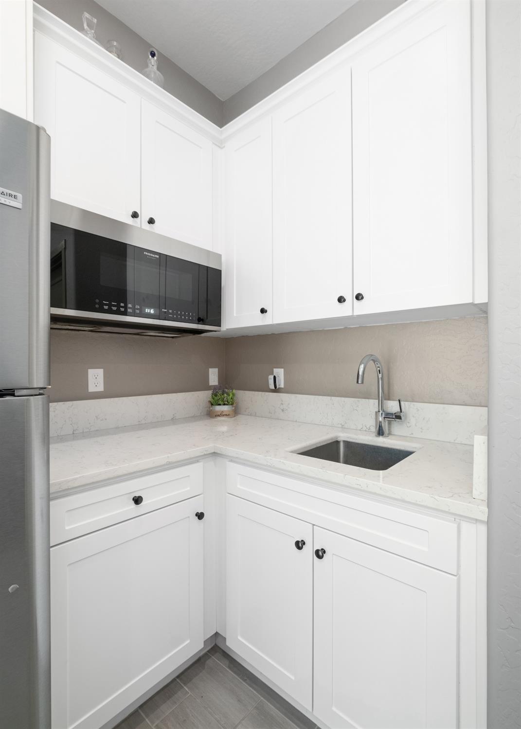 859 Maclure Avenue Madera, CA 93636 - Photo 39 of 53 a kitchen with stainless steel appliances granite countertop white cabinets and a sink