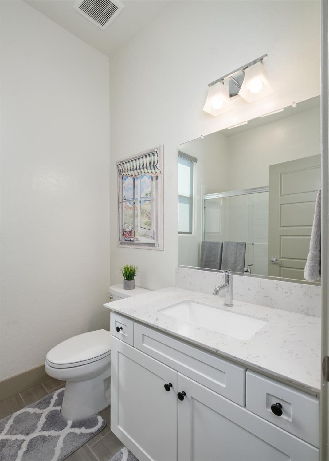 859 Maclure Avenue Madera, CA 93636 - Photo 41 of 53 a bathroom with a sink a toilet and mirror