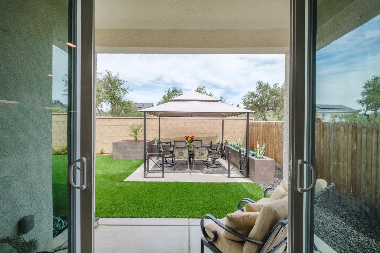 859 Maclure Avenue Madera, CA 93636 - Photo 42 of 53 a view of a patio with chairs and table potted plants