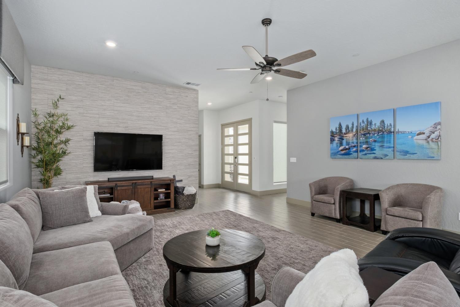 859 Maclure Avenue Madera, CA 93636 - Photo 10 of 53 a living room with furniture a flat screen tv and a large window