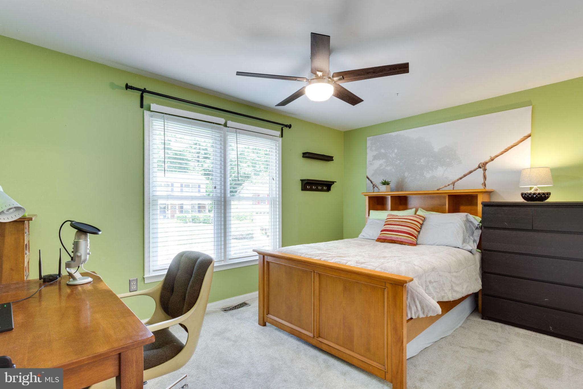 9147 Rockefeller Lane Springfield, VA 22153 - Photo 18 of 30 a bedroom with a bed and a chandelier
