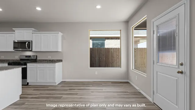 a view of a kitchen with a sink a refrigerator and window