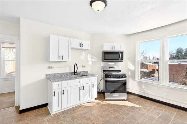 a kitchen with a sink cabinets and window