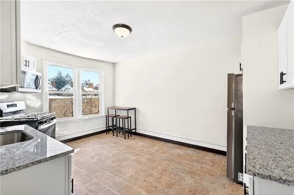 a room with a sink and a wooden floor