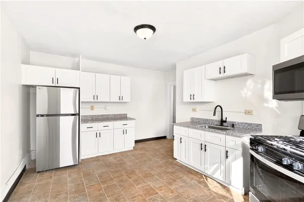 a kitchen with a sink stove and refrigerator