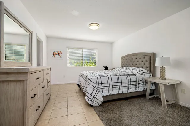 a bedroom with a bed and a dresser