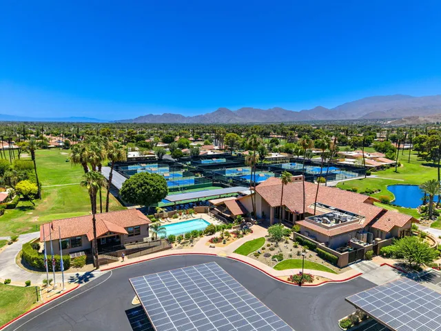 a view of a chairs and table in patio with a lake view