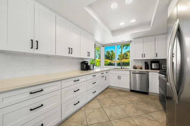 a kitchen with appliances cabinets and a window