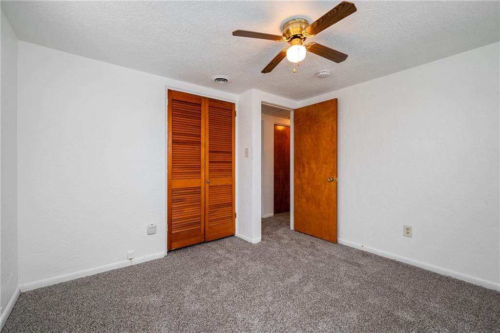 3504 Bevan Road North Versailles, PA 15137 - Photo 11 of 21 an empty room with closet and a ceiling fan