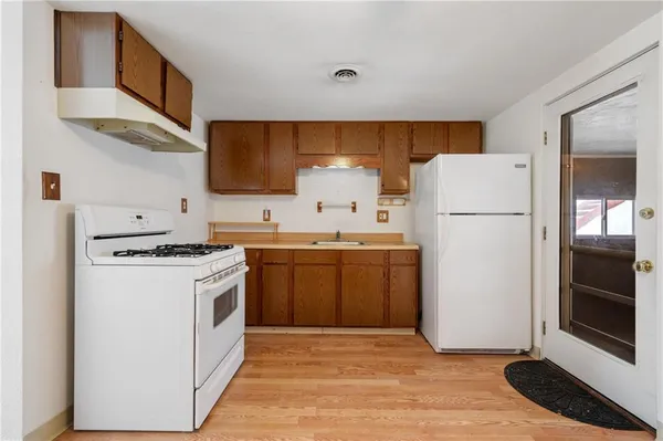 a kitchen with a white cabinets and white appliances