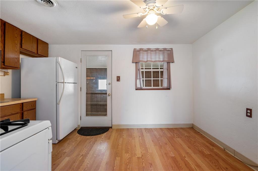 3504 Bevan Road North Versailles, PA 15137 - Photo 17 of 21 a view of a kitchen with a stove cabinets and a ceiling fan