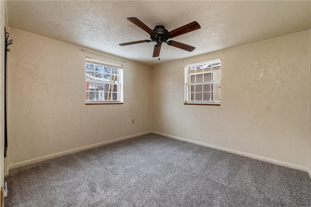 3504 Bevan Road North Versailles, PA 15137 - Photo 8 of 21 an empty room with ceiling fan and windows