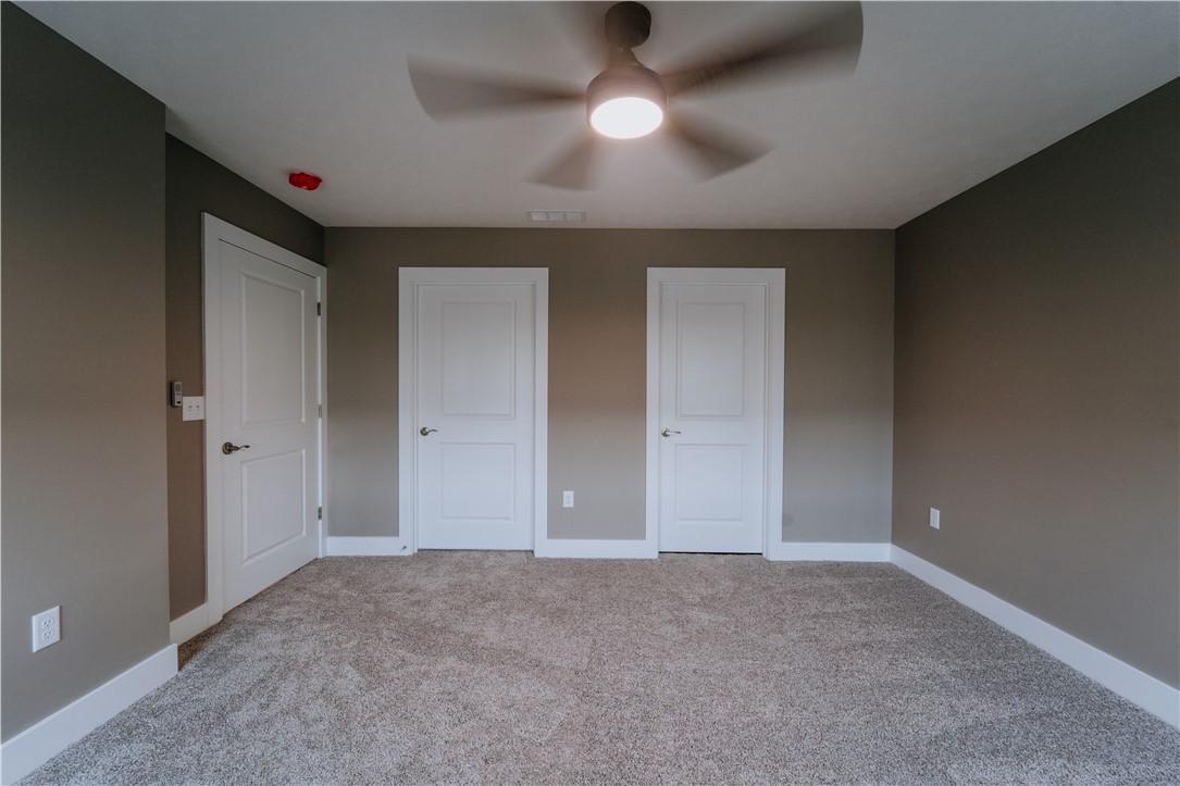 4528 West Ridgewood Road Springfield, OH 45503 - Photo 10 of 24 This spacious bedroom offers comfortable carpeting and a modern ceiling fan for ultimate comfort.